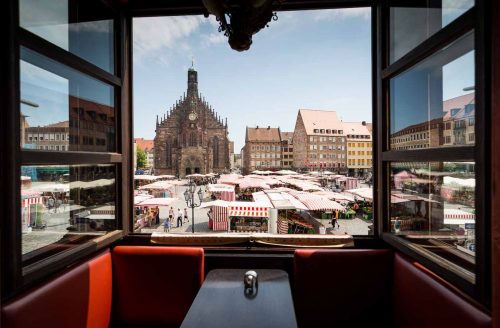 Nuremberg, Germany, June 2015.Daily open market named HauptMarkt front of the Church Fraun Kirche. Nuremberg, a city in Bavaria, is distinguished by its medieval architecture, including the fortifications and stone towers of its Altstadt (Old Town).