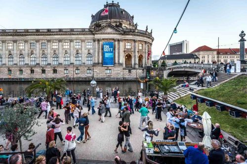 Berlin, June 2015. People dancing along the Spree river. Berlin is the capital of Germany, and one of the 16 states of Germany. With a population of 3.5 million people, Berlin is Germany's largest city. It is the second most populous city  and the seventh most populous urban area in the European Union