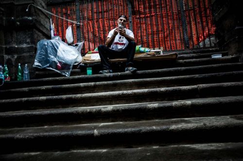 Naples, Italy. An italian homeless shaving in the street.However, high unemployment and waste management problems continue to affect Naples; Italian media have attributed the city's waste disposal issues to the activity of the Camorra organised crime network. In 2007, Silvio Berlusconi's government held senior meetings in Naples to demonstrate their intention to solve these problems.[However, the late-2000s recession had a severe impact on the city, intensifying its waste-management and unemployment problems. By August 2011, the number of unemployed in the Naples area had risen to 250,000, sparking public protests against the economic situation.In June 2012, allegations of blackmail, extortion and illicit contract tendering emerged in relation to the city's waste management issues