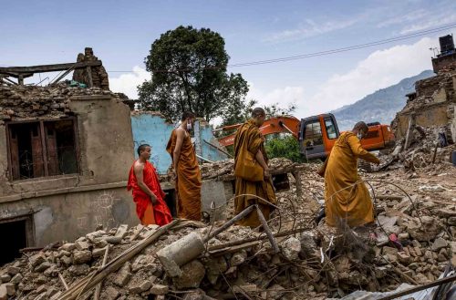 Nepal, 18 may 2015 For monks come to pray for the people of Dharmastali..People are cleaning up the rest of destroied houses in Dharmasthali.