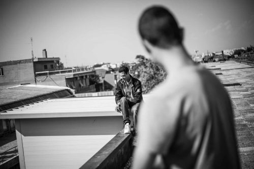 Rome, Italy, apr,2014.Peole on the roof of a building that has been just occpied. A group of homeless from both Italian and non-EU countries occupy an abandoned building that up to nine months ago belong to the offices of the National Social Security Institute (INPS).Un gruppo di senza casa sia italiani che provenienti da paesi extracomunitari occupano un edificio abbandonato che fino a 9 mesi fa era la sede di uffici dell Istituto Nazionale della Previdenza Sociale (INPS). A group of homeless from both Italian and non-EU countries occupy an abandoned building that up to nine months ago belong to the offices of the National Social Security Institute (INPS).Un gruppo di senza casa sia italiani che provenienti da paesi extracomunitari occupano un edificio abbandonato che fino a 9 mesi fa era la sede di uffici dell Istituto Nazionale della Previdenza Sociale (INPS). A group of homeless from both Italian and non-EU countries occupy an abandoned building that up to nine months ago belong to the offices of the National Social Security Institute (INPS).Un gruppo di senza casa sia italiani che provenienti da paesi extracomunitari occupano un edificio abbandonato che fino a 9 mesi fa era la sede di uffici dell Istituto Nazionale della Previdenza Sociale (INPS).