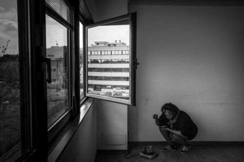 Rome, Italy, apr,2014. A woman is preparing food for her young doughter in the ground of an occpied building.A group of homeless from both Italian and non-EU countries occupy an abandoned building that up to nine months ago belong to the offices of the National Social Security Institute (INPS).Un gruppo di senza casa sia italiani che provenienti da paesi extracomunitari occupano un edificio abbandonato che fino a 9 mesi fa era la sede di uffici dell Istituto Nazionale della Previdenza Sociale (INPS).