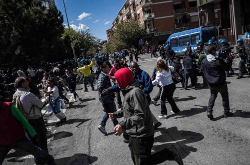 Rome, Italy, 16/4/2014.Several people have been injured in Rome as clashes erupted while Italian police evicted 350 squatter families caught up in the country's economic crisis. 350 families are locked on the roof of an occupied building.Riot police get ready to drag away some 350 squatter families from abandoned offices in Rome
